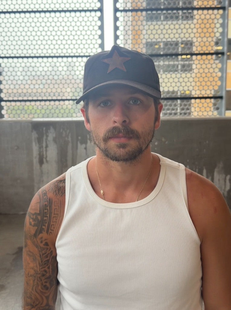 Unstructured black suede buckle-back hat — front view