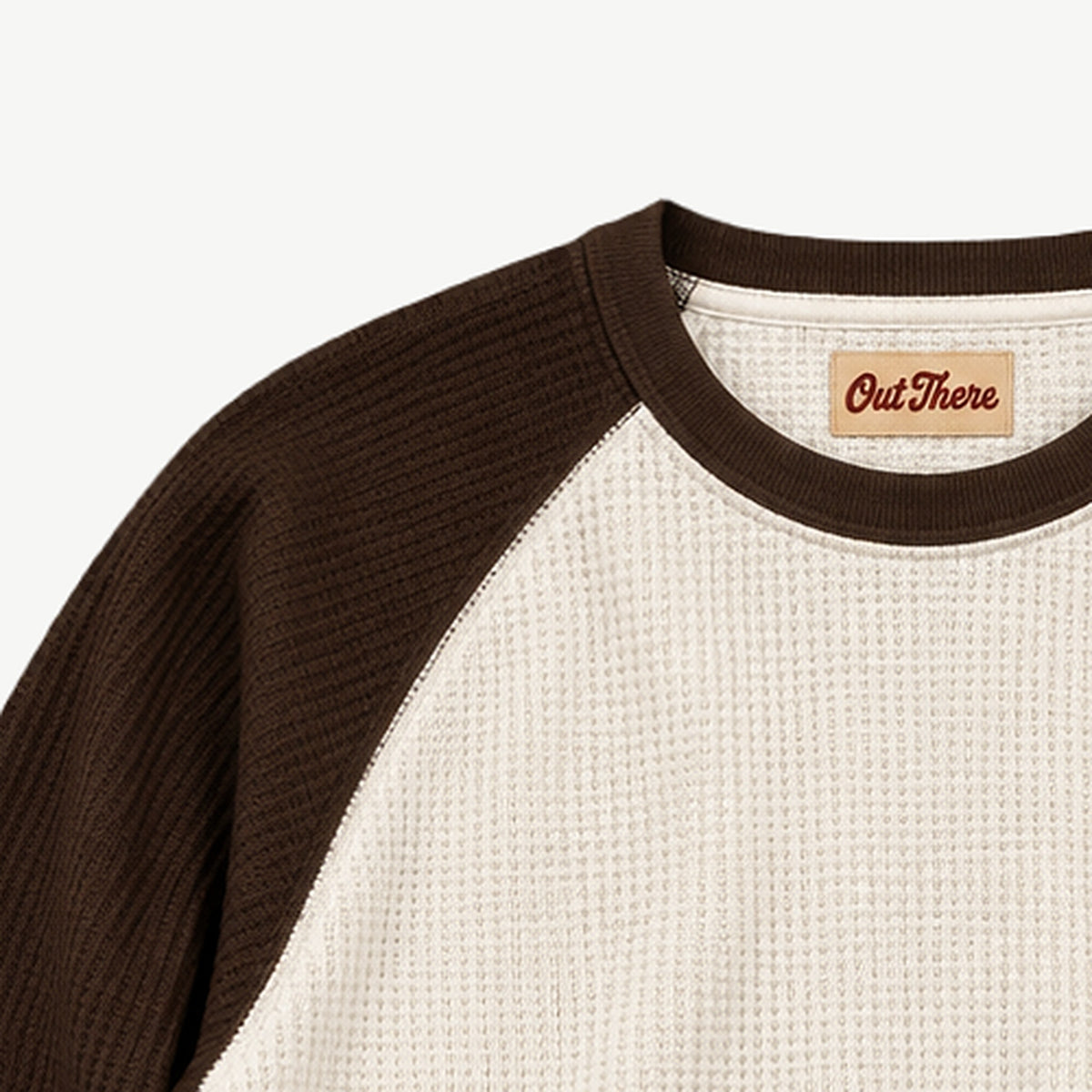 Close-up of the brown rib neck and raglan sleeve seam on the Egret & Brown Waffle Raglan