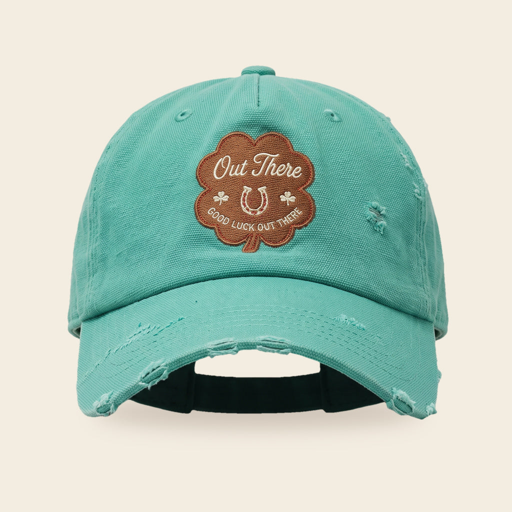Good Luck Out There cap front view with the four-leaf clover patch and hand distressed seafoam canvas brim