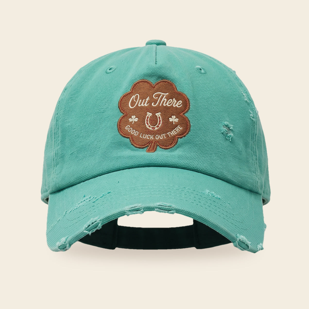 Good Luck Out There cap front view with the four-leaf clover patch and hand distressed seafoam canvas brim