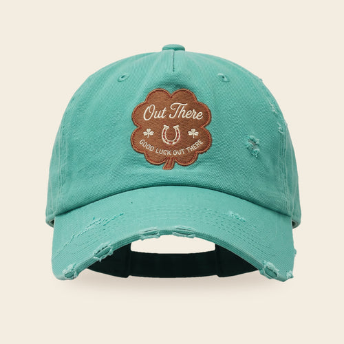 Good Luck Out There cap front view with the four-leaf clover patch and hand distressed seafoam canvas brim
